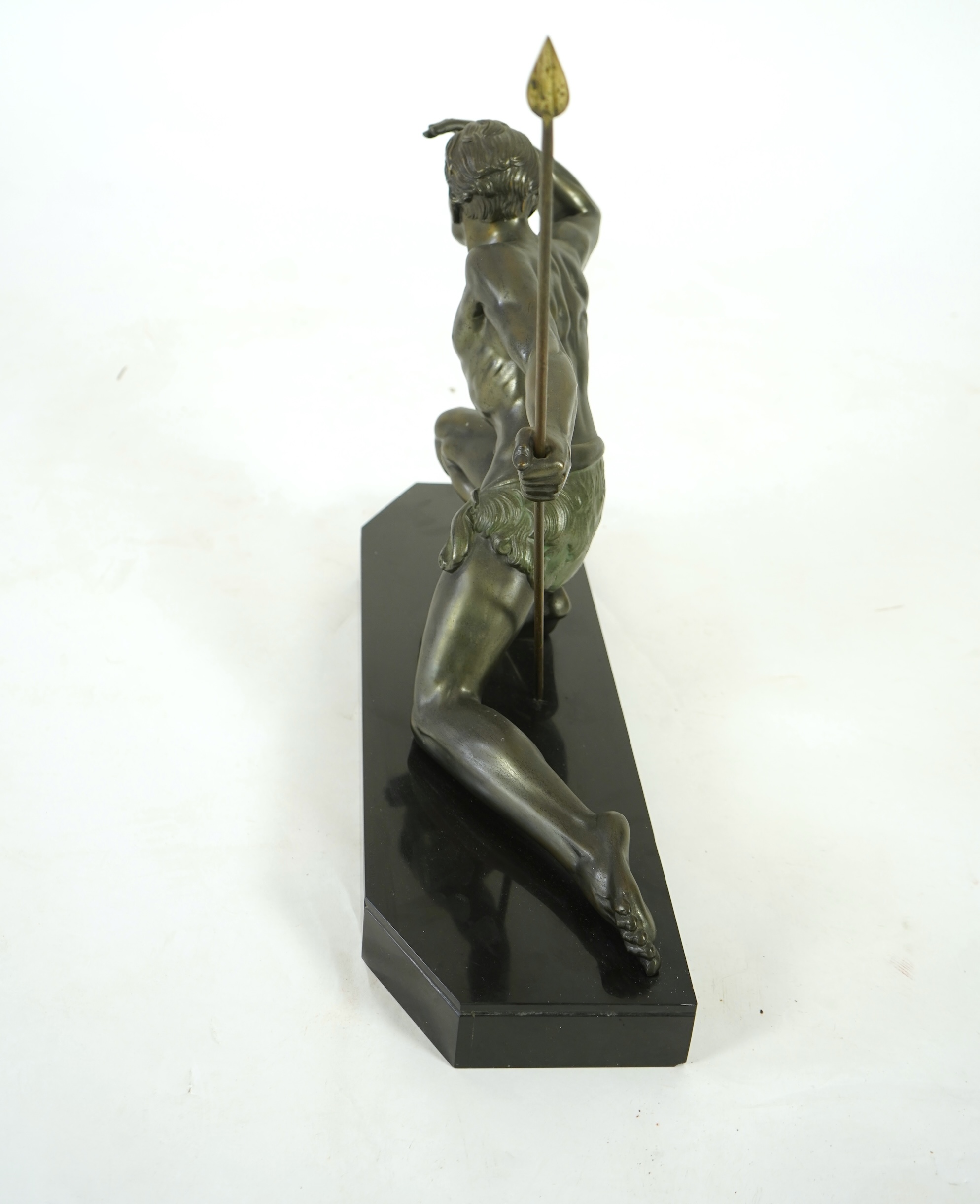 Manner of Jean de Roncourt (1869-1937) An Art Deco patinated bronze sculpture of a male hunter with spear on black marble stand